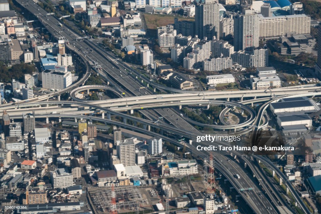 The interchange of Hanshin Expressway and Kinki Expressway in Higashiosaka city in Osaka prefecture in Japan daytime aerial view from airplane