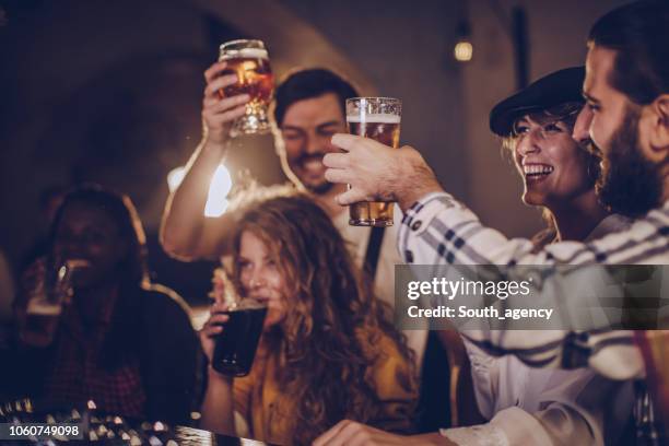 friends fun in pub - ale stock pictures, royalty-free photos & images