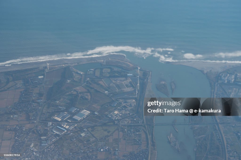 Pacific Ocean and mouth of Tenryu River in Iwata city in Japan sunset time aerial view from airplane