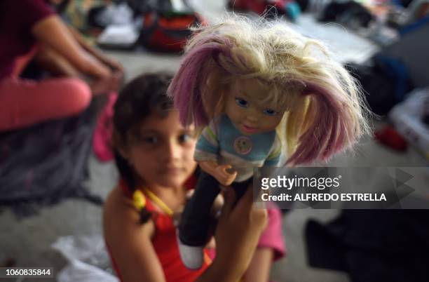 Girl taking part in a caravan of migrants from poor Central American countries -mostly Hondurans- moving towards the United States in hopes of a...