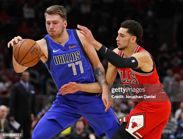 Luka Doncic of the Dallas Mavericks is challenged by Zach LaVine of the Chicago Bulls at the United Center on November 12, 2018 in Chicago, Illinois....