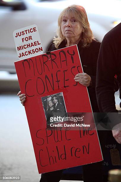 Michael Jackson fan holds a sign calling on Dr. Conrad Murray to confess to murdering Jackson to "spare the children" outside the courthouse as...