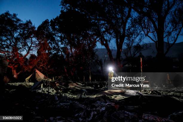 County firefighters check burned areas for hotspots after the Woolsey fire ravaged a neighborhood on Harvester road, November 12, 2018 in Malibu,...