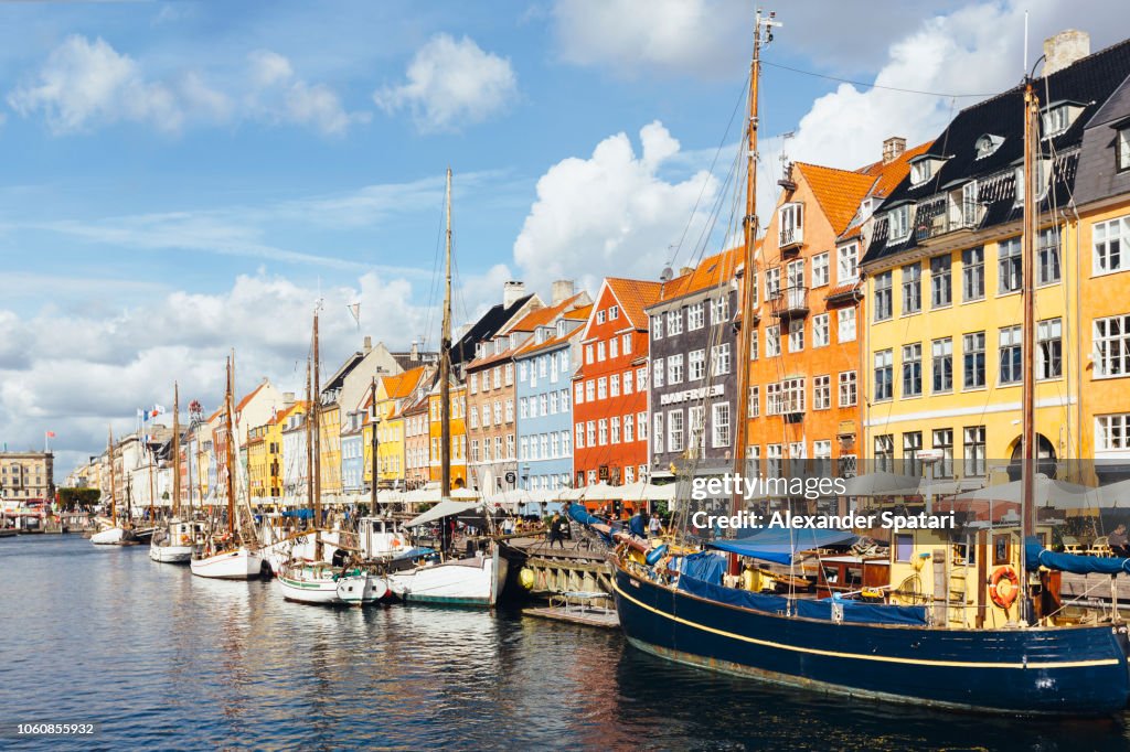 Copenhagen skyline on a sunny day with Nyhavn harbor and colorful houses, Denmark