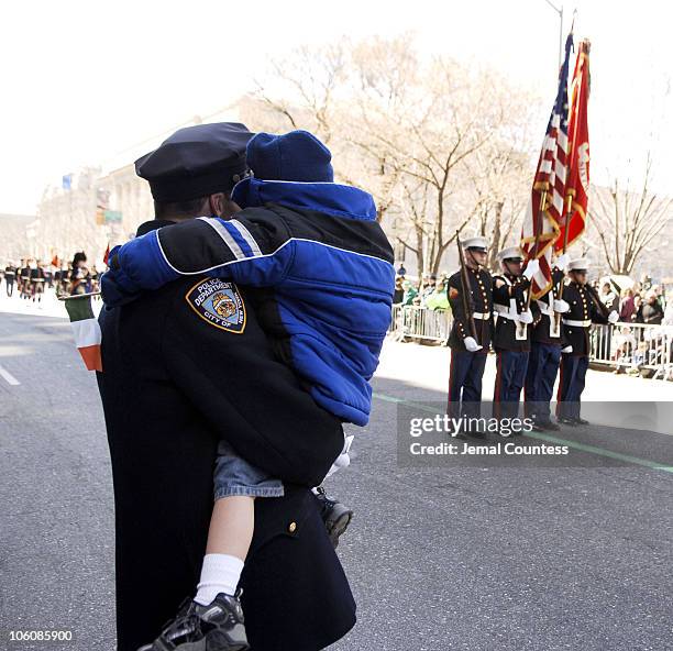 Father and son watch the 245th Annual St. Patrick's Day Parade on 5th Avenue in New York City on March 17, 2006