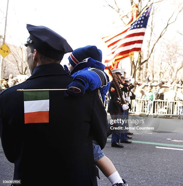 Father and son watch the 245th Annual St. Patrick's Day Parade on 5th Avenue in New York City on March 17, 2006