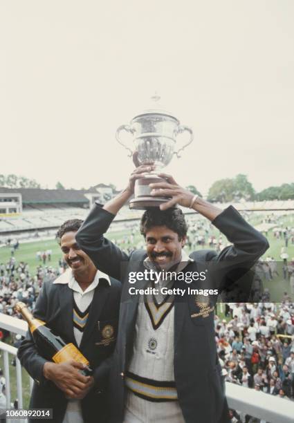 India players Kapil Dev lifts the trophy as Man of the Match Mohinder Amarnath looks on after the 1983 Prudential World Cup Final victory against...