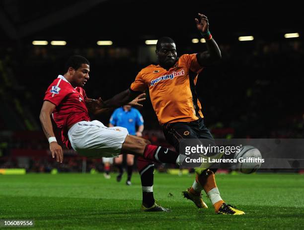 Bebe of Manchester United scores the opening goal under pressure from George Elokobi of Wolves during the Carling Cup fourth round match between...