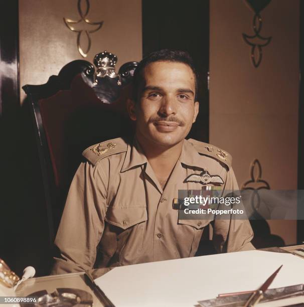 King Hussein of Jordan pictured wearing military uniform seated at a desk in Amman, Jordan in November 1960.