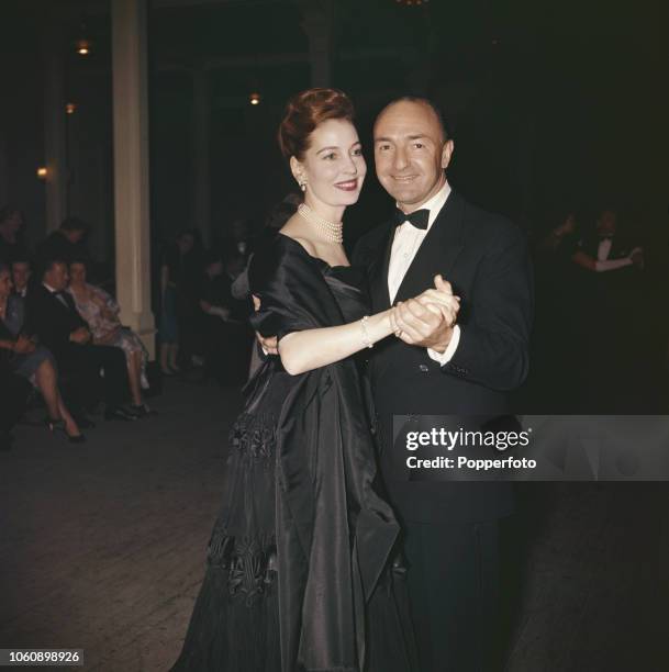 British Conservative Party politician and Secretary of State for War John Profumo pictured dancing with his wife Valerie Hobson at a civic reception...