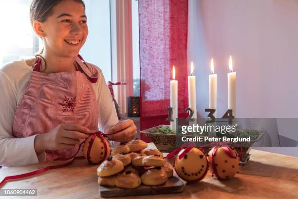 girl smiling while making christmas decorations - bun bread stock pictures, royalty-free photos & images