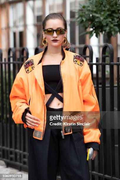 Fashion Designer Jeanne Touzet wears an Asger Juel Larsen jacket, Max Mara trousers and Chanel earrings during London Fashion Week September 2018 on...