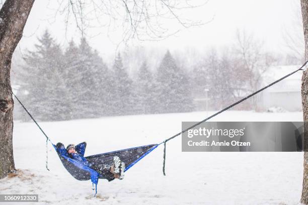 man in hammock on a winter day - sioux falls stock pictures, royalty-free photos & images
