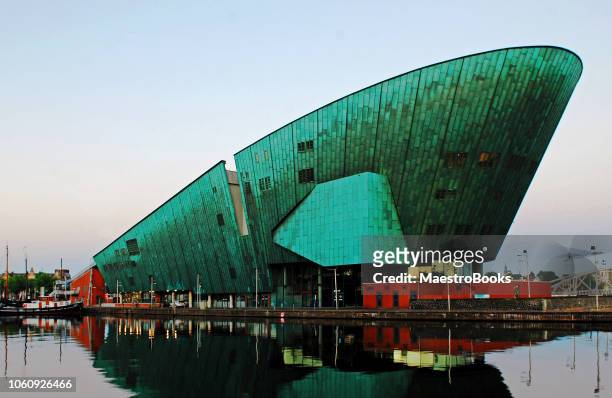 the nemo museum of amsterdam at twilight. - nemo stock pictures, royalty-free photos & images