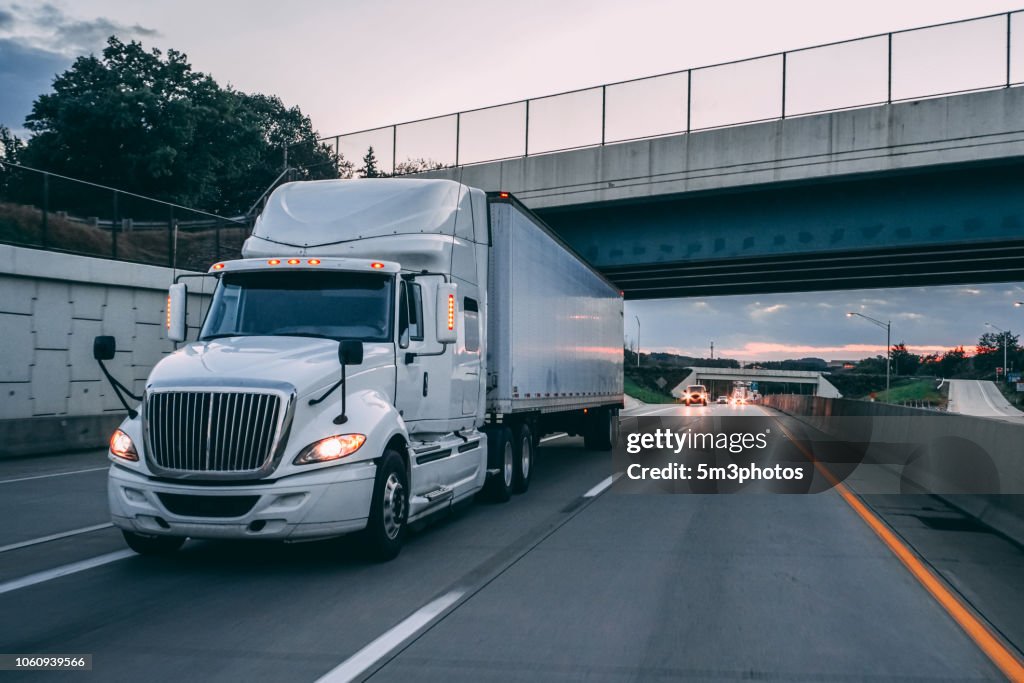 18 wheeler truck on road at night