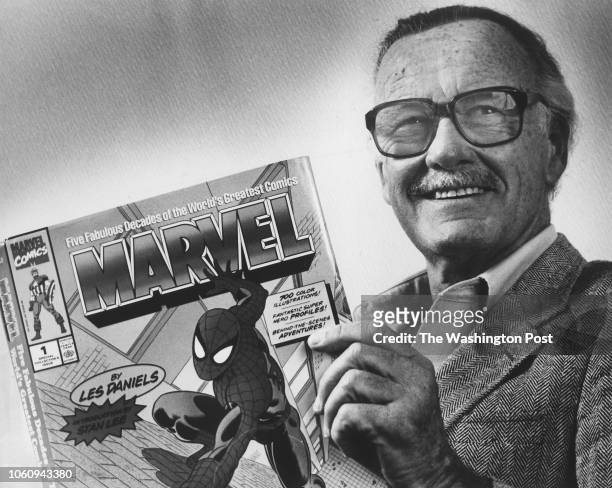Marvel Comics Publisher, Stan Lee, poses with a book of "Spider Man" comics which he created along with comics on the "Hulk" and others. Photo from...