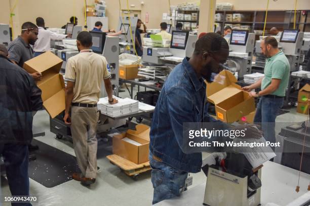Election workers sort ballots so that the Florida senate and governor votes can be separately recounted at the Broward County Supervisor of Elections...