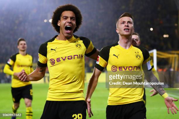 Marco Reus of Borussia Dortmund celebrates with teammate Axel Witsel after scoring his team's first goal during the Bundesliga match between Borussia...