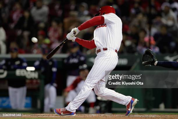 Designated hitter Rhys Hoskins of the Philadelphia Phillies hits a solo homer to make it 1-0 in the bottom of 2nd inning during the game four between...