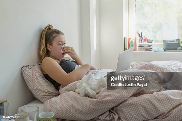 teenage girl in bed with the flu - cold illness stock pictures, royalty-free photos & images