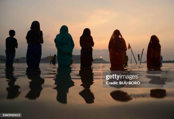 Indian Hindu devotees offer prayers during the 'Chhat Puja' on the banks of the Brahmaputra River in Guwahati on November 13, 2018. The Chhath...