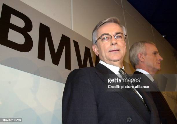 The BMW chairman Joachim Milberg and the chief financial officer Helmut Panke are standing in front of a big sign of BMW before the press conference...