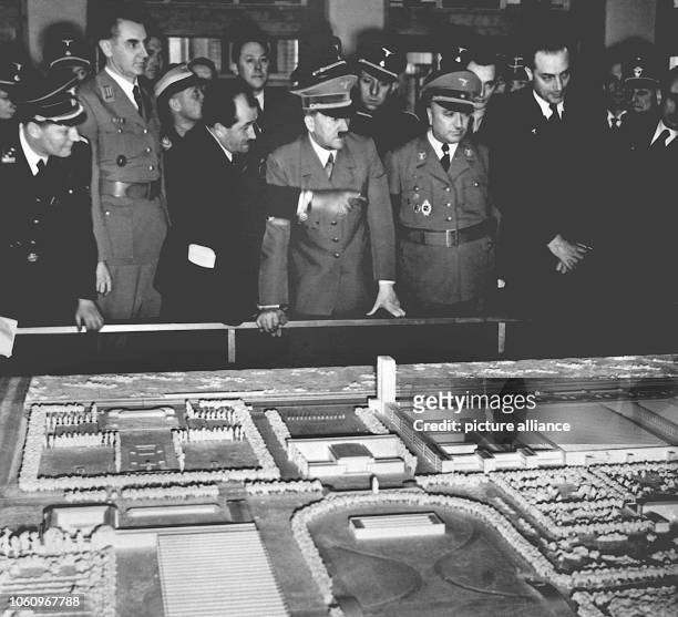 Reich Chancellor Adolf Hitler at the modell of the Volkwagen factory. On 26 May 1938, he laid the foundation stone for the Volkswagen factory on the...