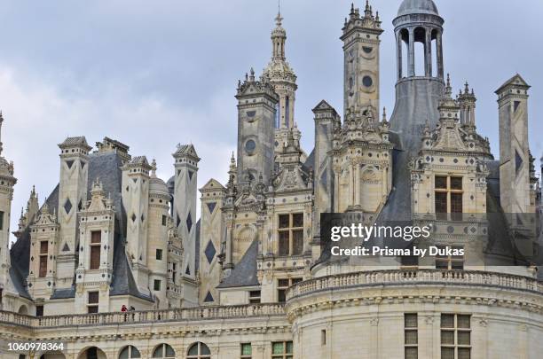 The magnificent turrets, chimneys and elaborate roof decorations of the Chateau de Chambord, France.
