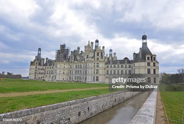 The royal Chateau de Chambord with a canal leading to the ornamental moat.