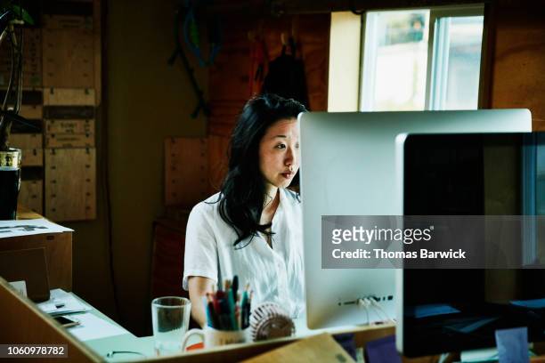 Female businesswoman working on computer in small office