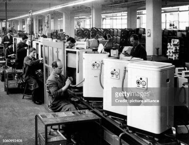Picture of employees who montage washing machines in the AEG works in the 1950s in Nuremberg .