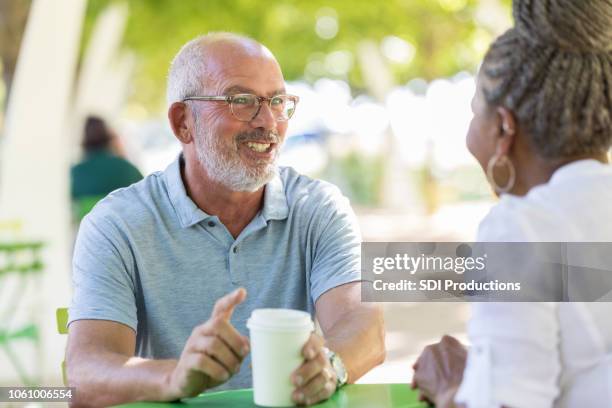 during a lunch break, two business partners talk over coffee - blind date stock pictures, royalty-free photos & images