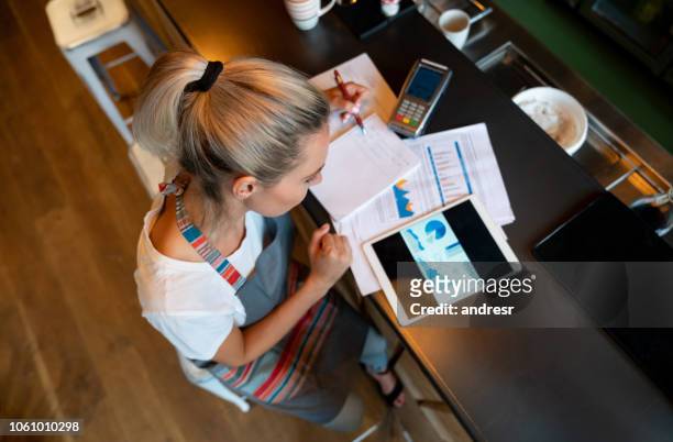 business manager doing the books at a bar - business plan stock pictures, royalty-free photos & images