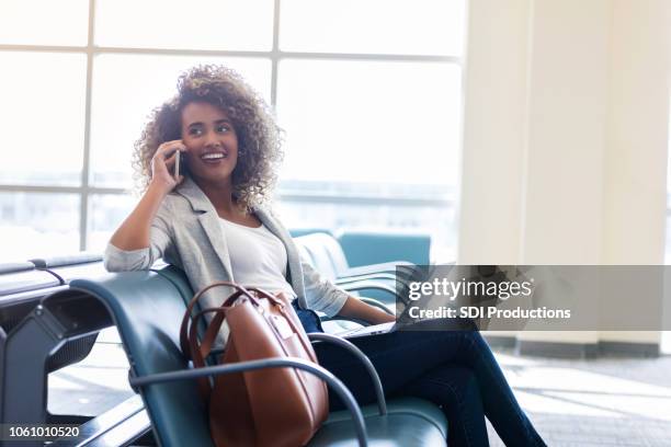 young businesswoman works while waiting to board plane - airplane phone stock pictures, royalty-free photos & images