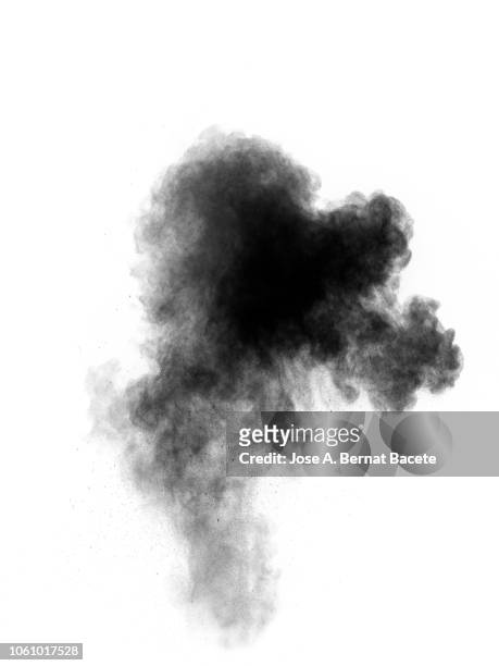 full frame of forms and textures of an explosion of powder and smoke of color gray and black on a white background. - black smoke stock pictures, royalty-free photos & images