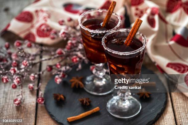 mulled wine and frozen berries on the wooden table - clove stock pictures, royalty-free photos & images