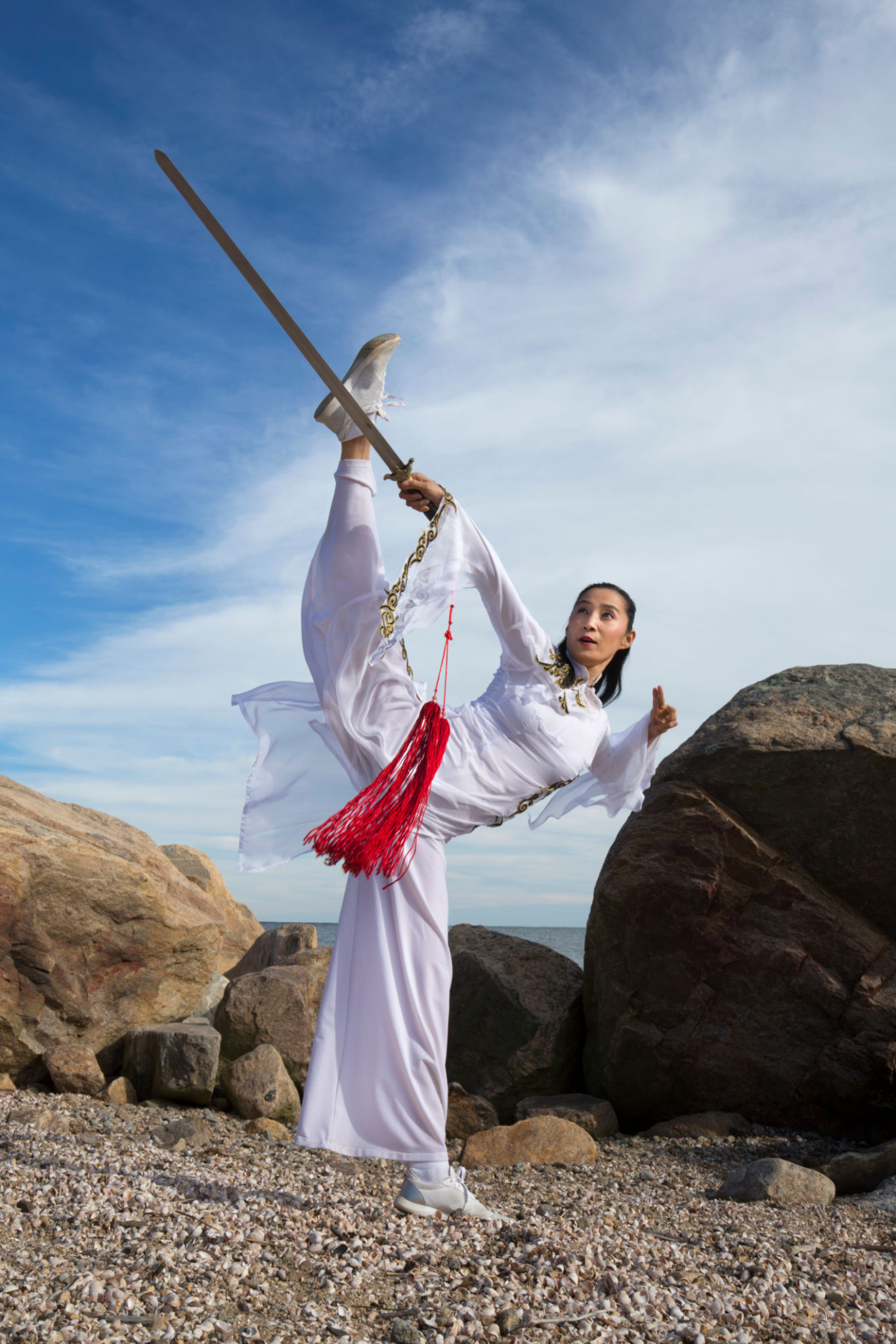 Young woman dancer with a sword on a Connecticut beach. Young woman dancer with a sword on a Connecticut beach.