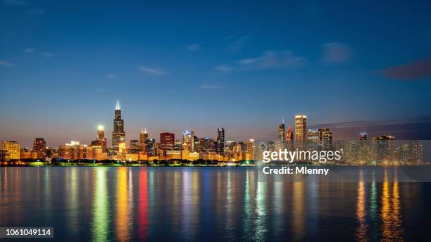 chicago skyline panorama lake michigan reflections at night - chicago illinois skyline stock pictures, royalty-free photos & images
