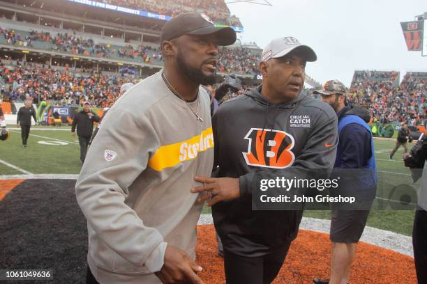 Head Coach Marvin Lewis of the Cincinnati Bengals shares a moment at midlfield with Head Coach Mike Tomlin of the Pittsburgh Steelers after their...