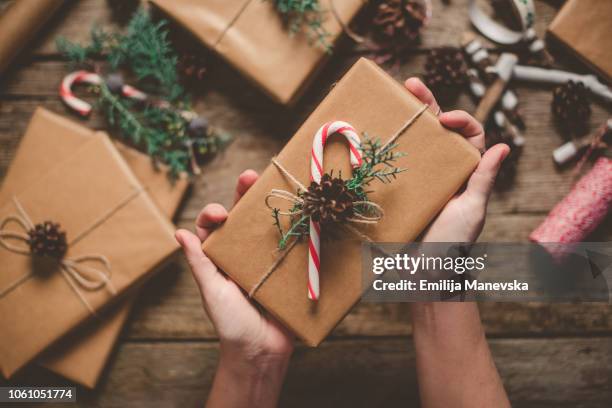 female person holding christmas gift - wrapped stock pictures, royalty-free photos & images