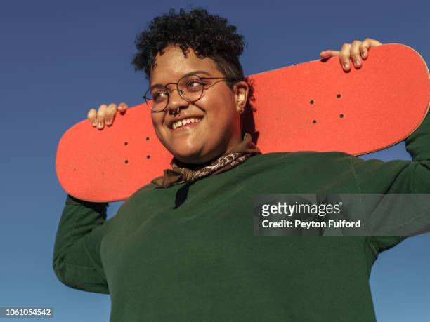 Woman Laughing with Orange Skateboard
