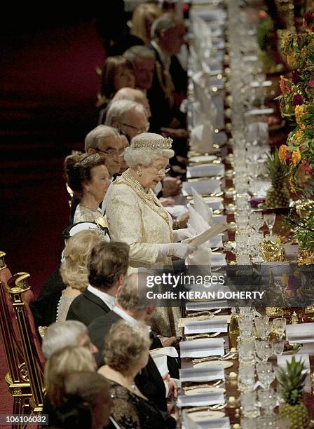 Britain's Queen Elizabeth delivers a speech before a banquet held during the state visit of Qatar's Emir Sheikh Hamad bin Khalifa al Thani and his...