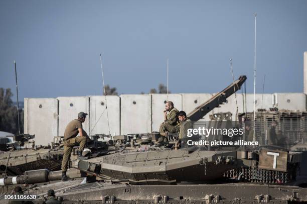 November 2018, Israel, ---: Israeli soldiers sit on top of Merkava battle tanks stationed along the Israeli-Gaza border. According to Israeli army...