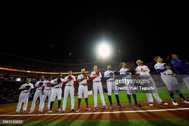 All-Stars are seen on the base path during the playing of the national anthems prior to Game 4 of the Japan All-Star Series against Team Japan at...