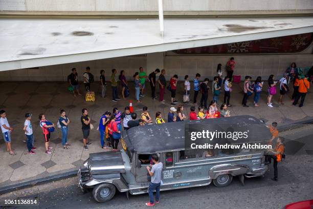 People queueing up to board the local free Jeepney in Makati, Metro Manila, Philippines. A Jeepneys, or Dyipni in Filipino, are repurposed US...