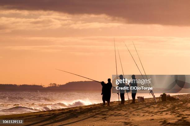 four adult people fishing, la pedrera beach, coastline, uruguay - uruguai imagens e fotografias de stock