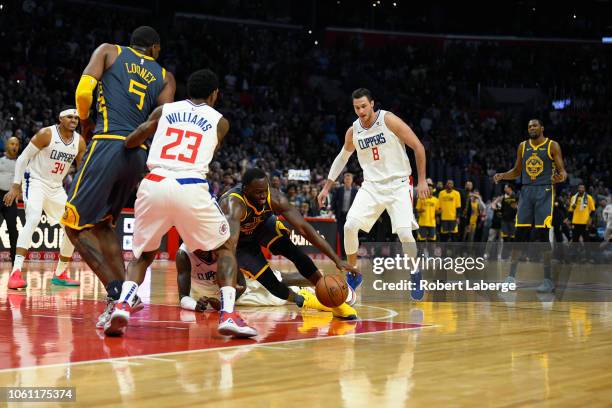 Draymond Green of the Golden State Warriors loses control of the ball in the final seconds of the fourth quarter as Kevin Durant of the Warriors...