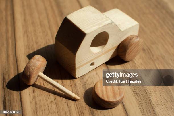 a broken wooden toy car on the table - broken toy stock pictures, royalty-free photos & images