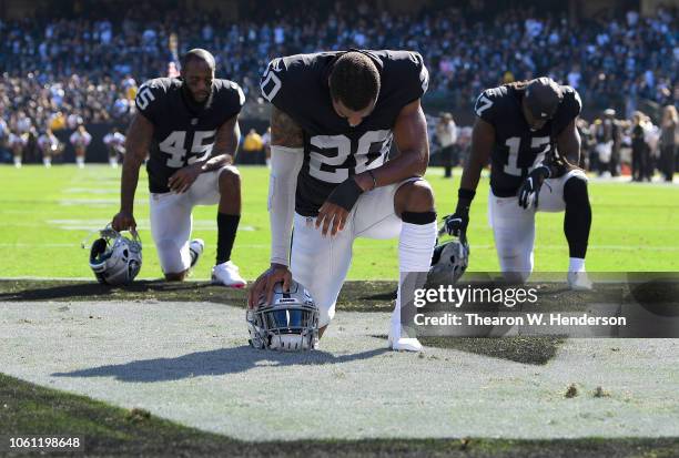 Daryl Worley, Dominique Rodgers-Cromartie and Dwayne Harris of the Oakland Raiders kneel and pray prior to the start of their game against the...