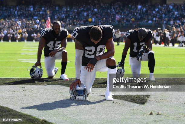 Daryl Worley, Dominique Rodgers-Cromartie and Dwayne Harris of the Oakland Raiders kneel and pray prior to the start of their game against the...
